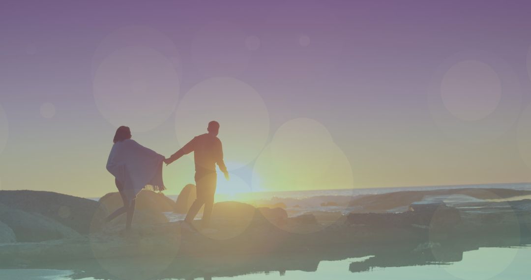 Happy Couple Walking at Sunset on Beach