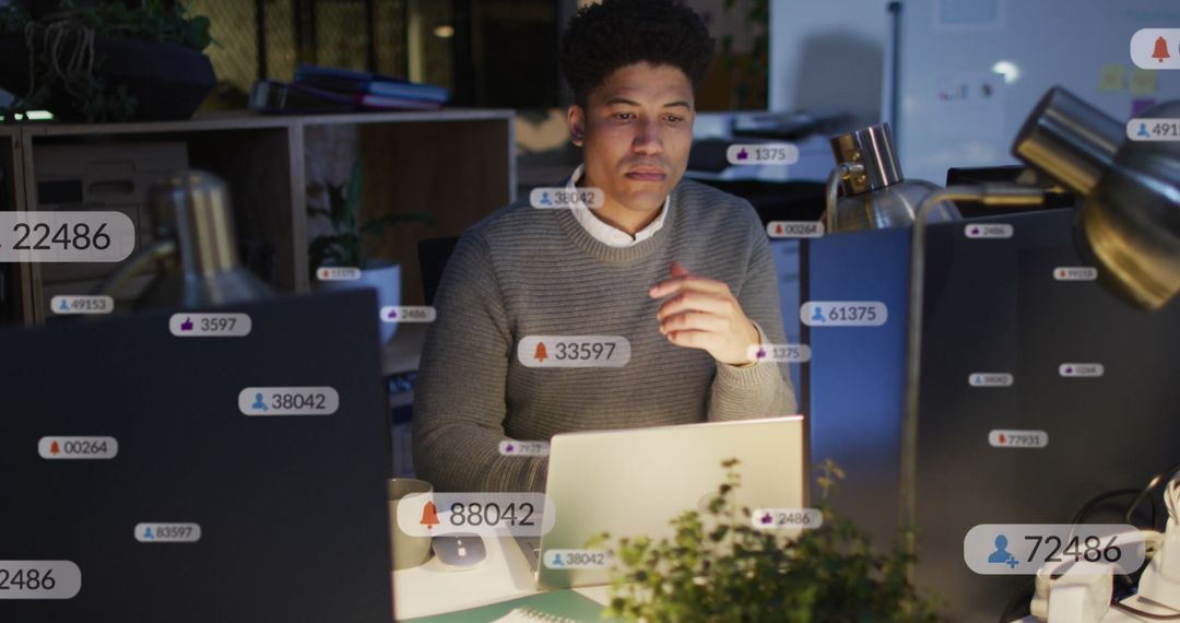 Man Analyzing Social Media Data Notifications on Laptop
