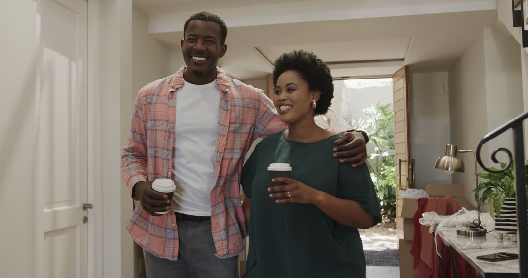 Smiling Friends Enjoying Coffee indoors, Embraced in Warm Friendship