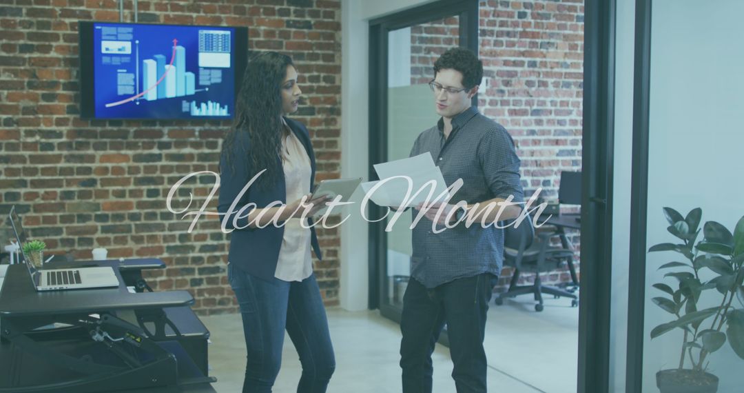 Diverse Team Discussing During Heart Month in Modern Office