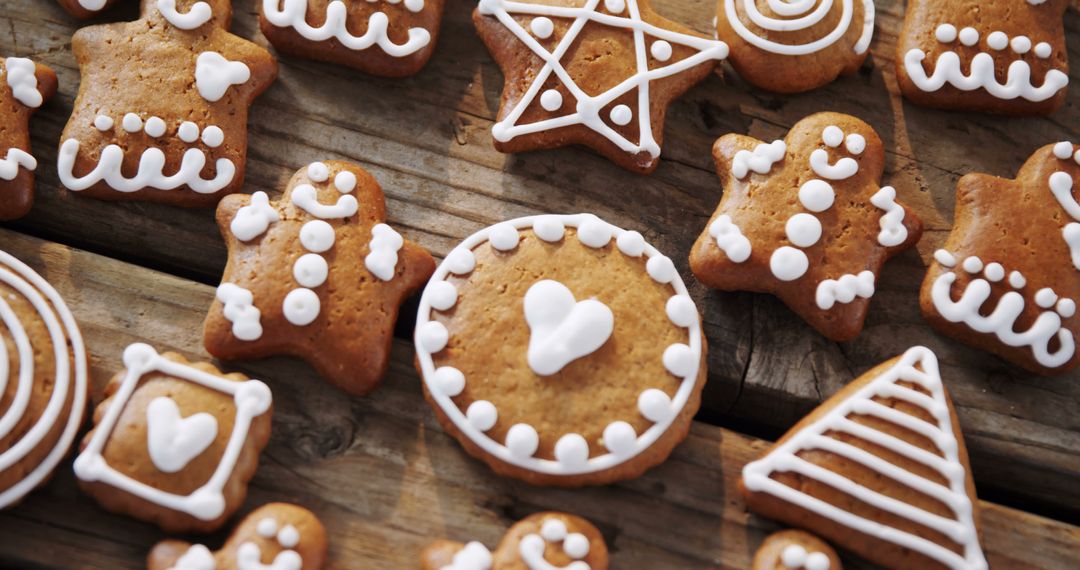 Assorted Festive Gingerbread Cookies with Icing on Wooden Table - Free Images, Stock Photos and Pictures on Pikwizard.com