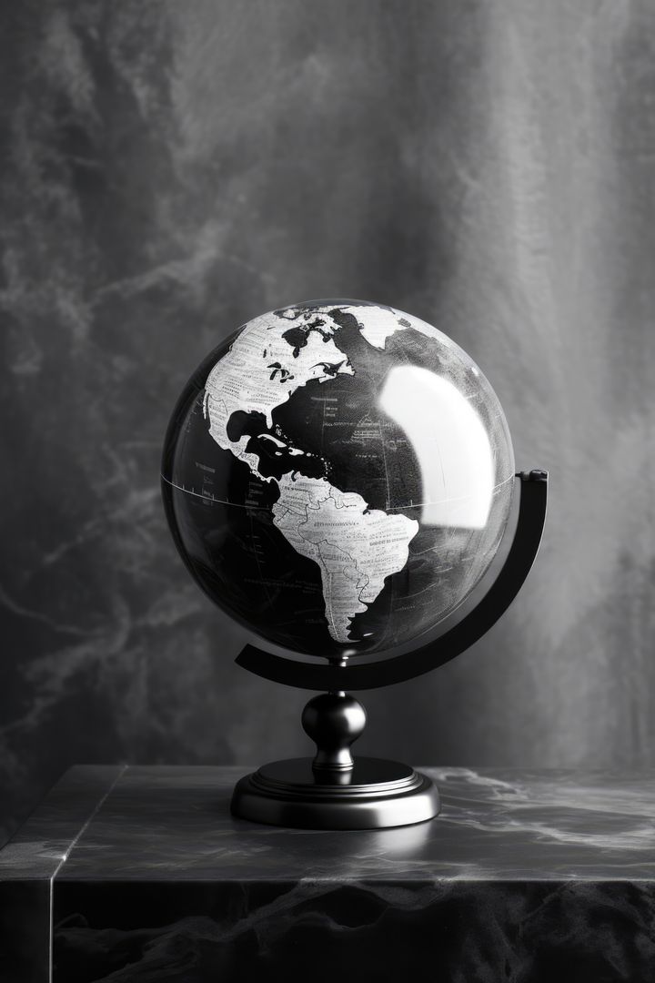A black and white globe sits on a table, with copy space - Free Images, Stock Photos and Pictures on Pikwizard.com