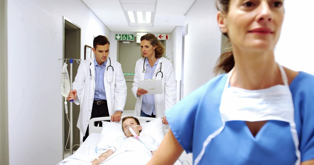 Emergency Pediatric Team Rushing Child on Gurney Down Hospital Corridor with IV and Oxygen Support