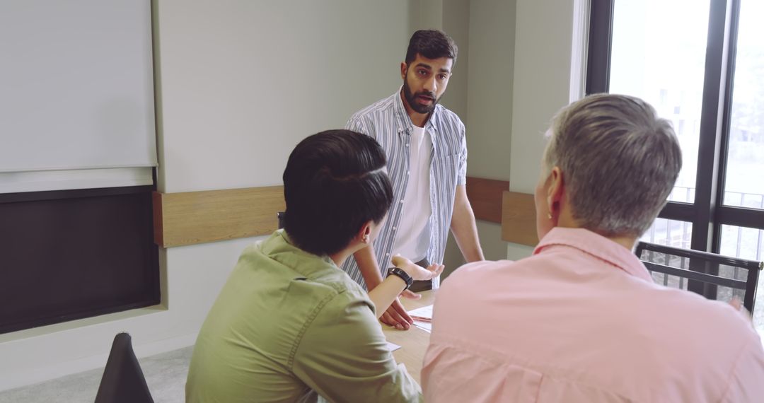 Diverse Male Coworkers Engaging in Solution-Focused Discussion at Office