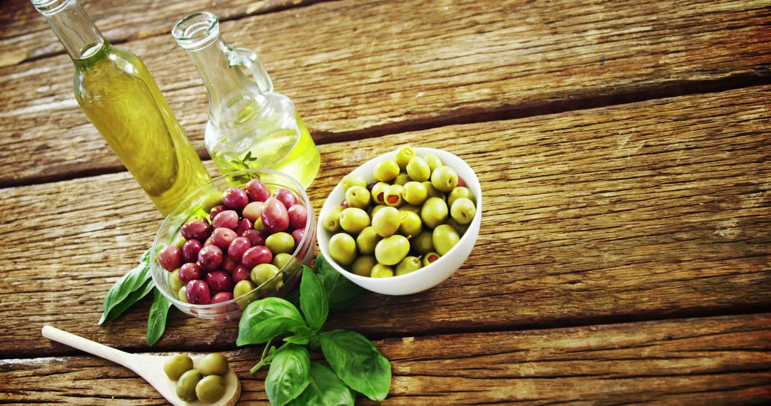 Fresh Olives and Olive Oil on Wooden Table - Free Images, Stock Photos and Pictures on Pikwizard.com