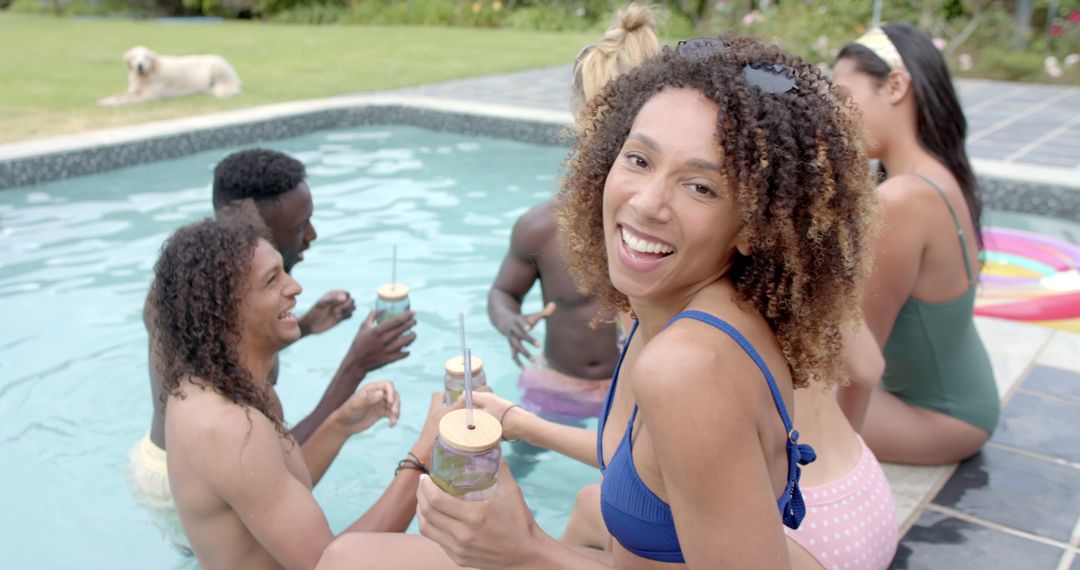 Friends Having Fun at Poolside Gathering with Drinks and Laughter