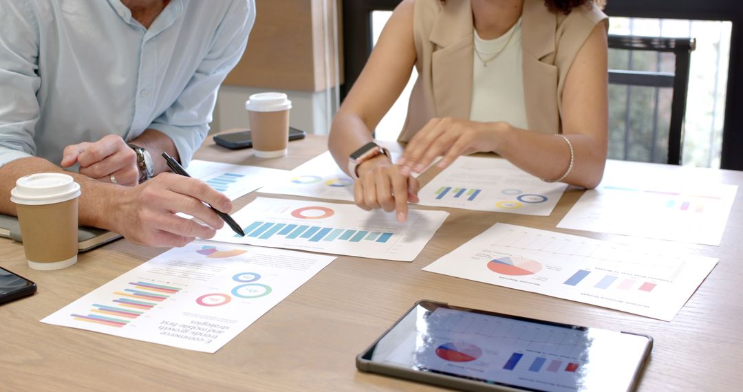 Collaborative Business Meeting with Printed Charts and Technology