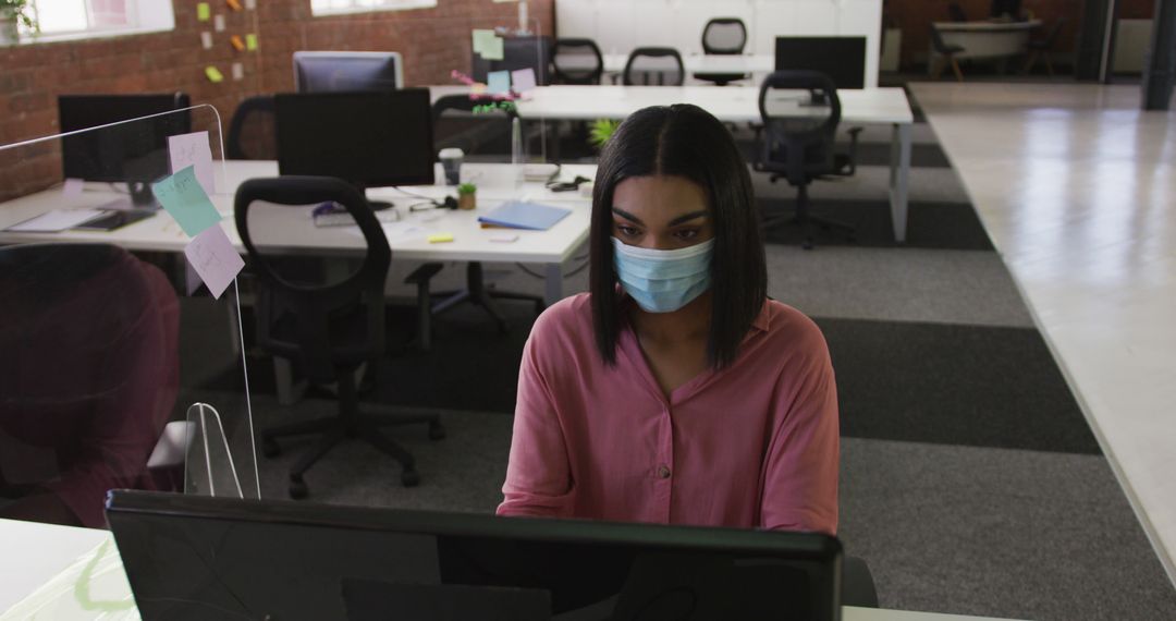 Woman Wearing Face Mask Working in Modern Office on Computer - Free Images, Stock Photos and Pictures on Pikwizard.com