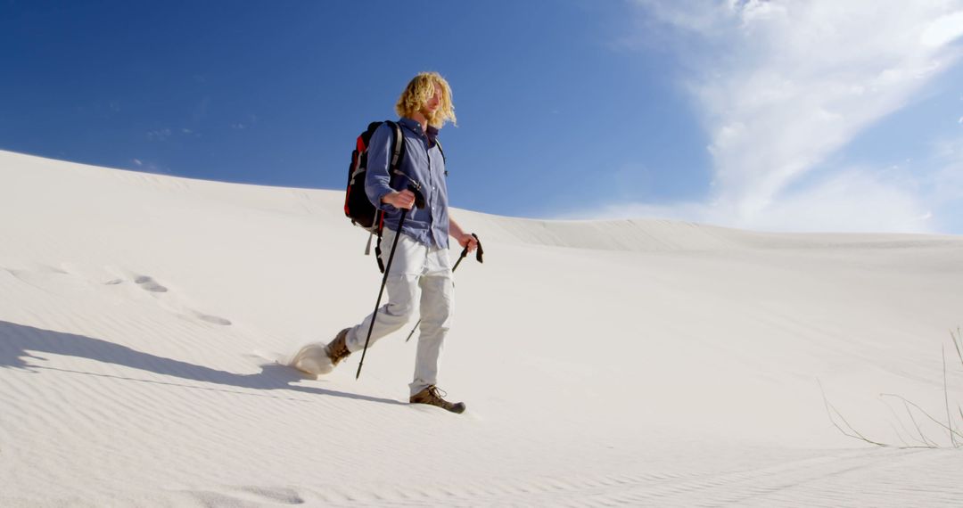 Man Hiking Adventure Across Vast Desert Sands