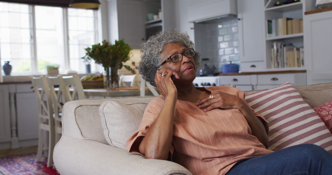 Elderly Woman having Phone Conversation in Cozy Living Room - Free Images, Stock Photos and Pictures on Pikwizard.com