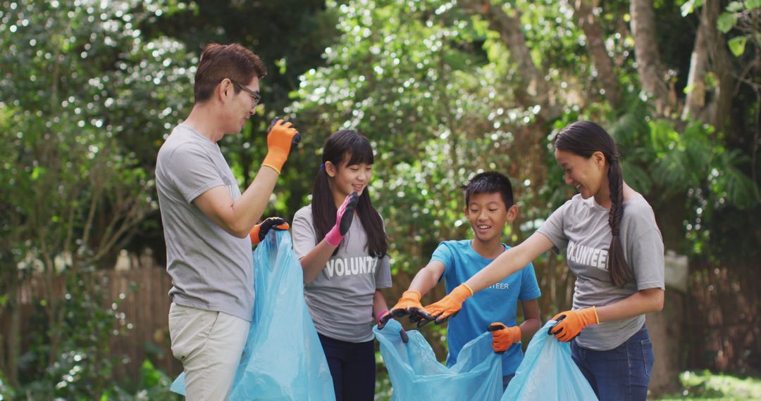 Happy Volunteers Collecting Litter in Park - Free Images, Stock Photos and Pictures on Pikwizard.com