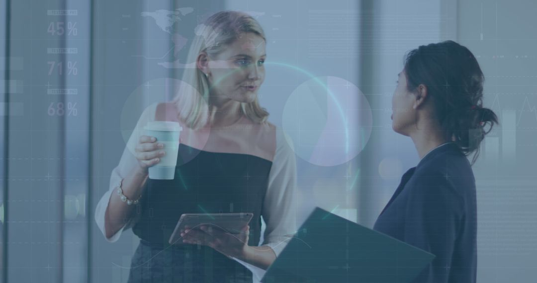 Businesswomen Discussing Digital Data Insights over Coffee