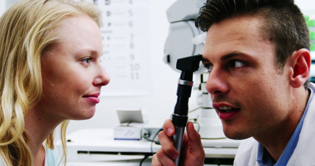 Optometrist Examining Patient Using Ophthalmoscope in Eye Clinic - Free Images, Stock Photos and Pictures on Pikwizard.com