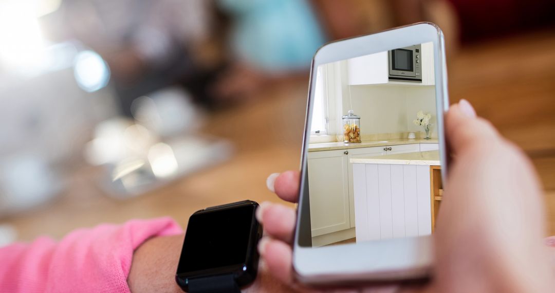 Person Using Smartphone to View Kitchen Interior Design