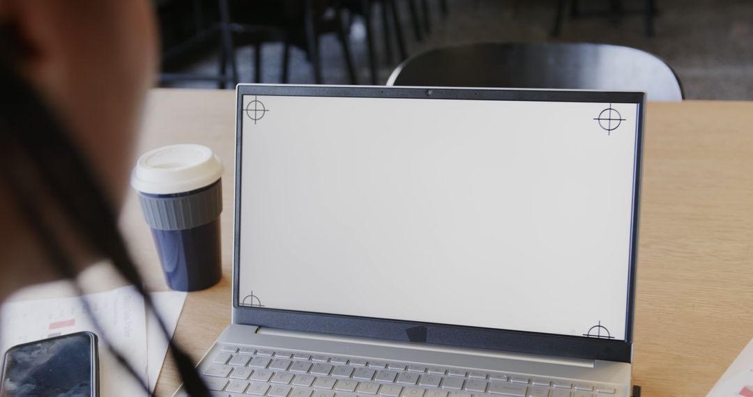 Person Viewing Blank Laptop Screen with Coffee Cup on Table - Free Images, Stock Photos and Pictures on Pikwizard.com