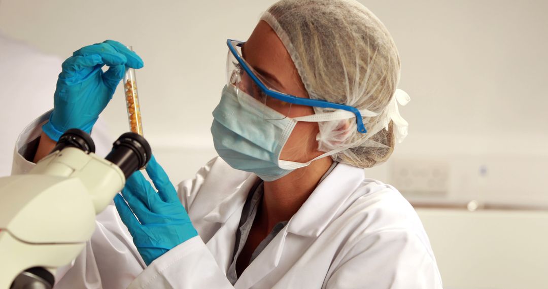 Female Scientist Examining Test Tube in Laboratory - Free Images, Stock Photos and Pictures on Pikwizard.com