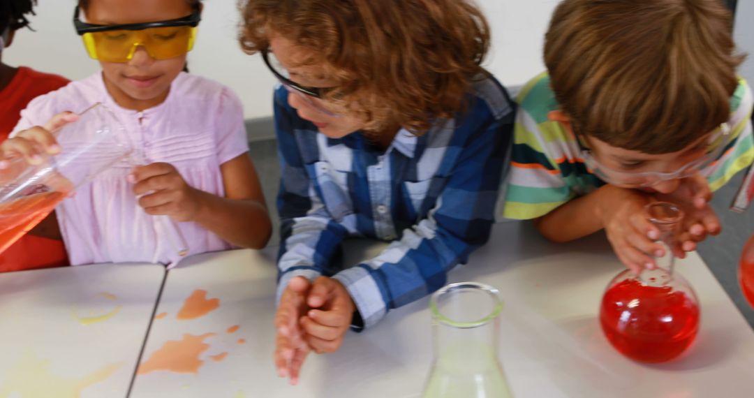 Children Conducting Science Experiment with Colorful Liquids in Laboratory - Free Images, Stock Photos and Pictures on Pikwizard.com