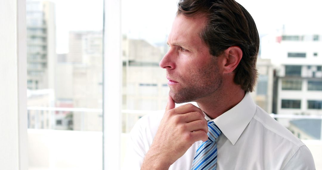 Businessman thinking with city view in background - Free Images, Stock Photos and Pictures on Pikwizard.com