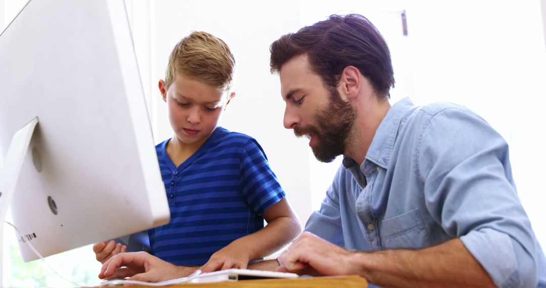 Father and Son Using Computer for Homework Inside Bright Room - Free Images, Stock Photos and Pictures on Pikwizard.com