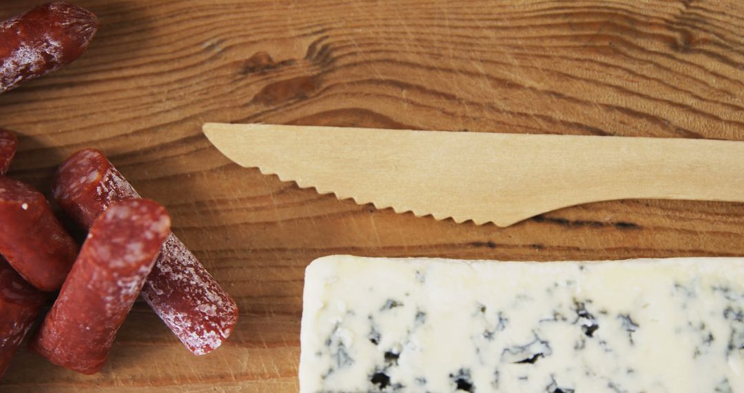 Assorted Meat and Cheese with Wooden Knife on Rustic Table - Free Images, Stock Photos and Pictures on Pikwizard.com