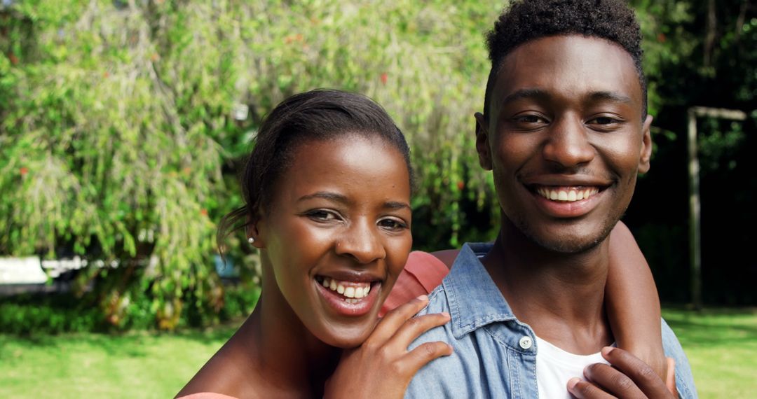 Joyful Couple Smiling Together in Green Park Setting