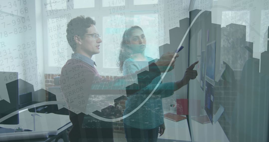 Two Professionals Collaborating on Data Analysis in Modern Office