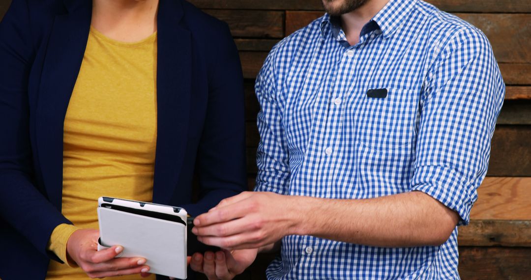 Colleagues Collaborating with Tablet in Modern Office