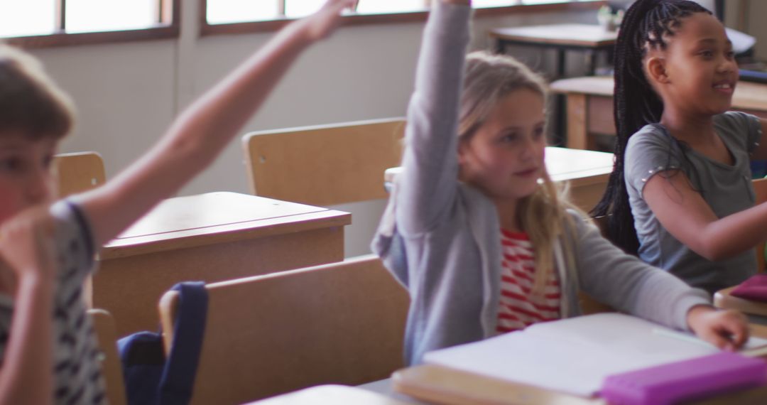 Engaged Children Raising Hands in Classroom During Lesson - Free Images, Stock Photos and Pictures on Pikwizard.com