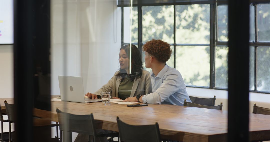 Diverse Colleagues Collaborating in Stylish Office with Modern Technology