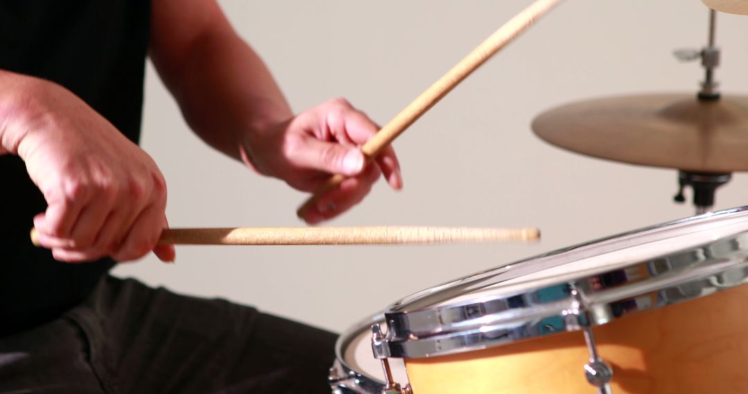 Drummer playing his drum kit on white background - Free Images, Stock Photos and Pictures on Pikwizard.com