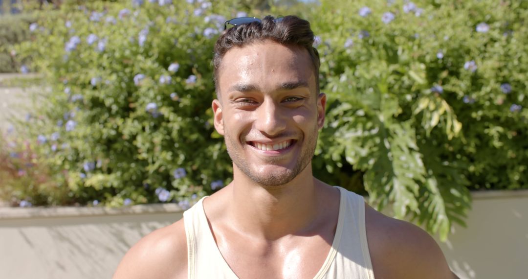 Smiling Man in Tank Top Outdoors on Sunny Day - Free Images, Stock Photos and Pictures on Pikwizard.com