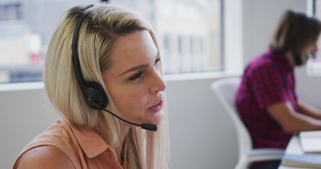 Customer Service Representative Engaged in Call in Modern Office