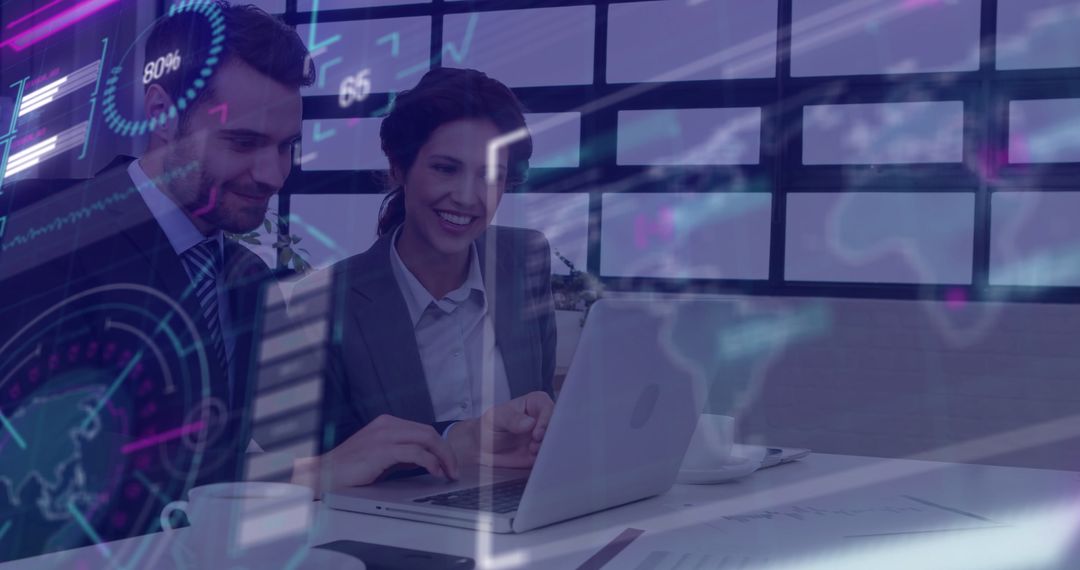 Colleagues Analyzing Data on Laptop with Digital Chart Overlay