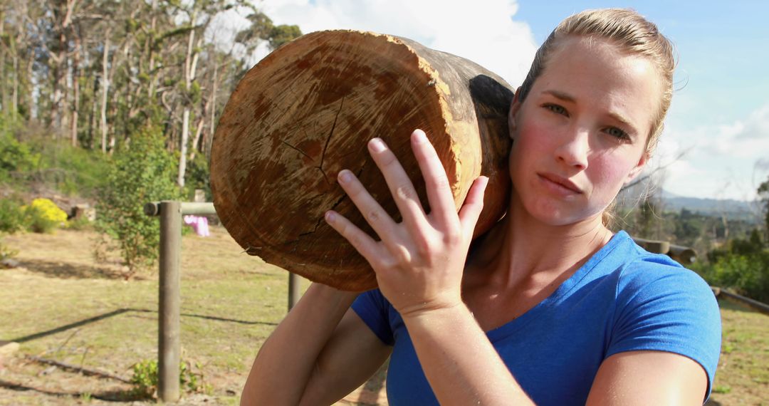 Strong Woman Carrying Heavy Log in Outdoor Fitness Setting - Free Images, Stock Photos and Pictures on Pikwizard.com