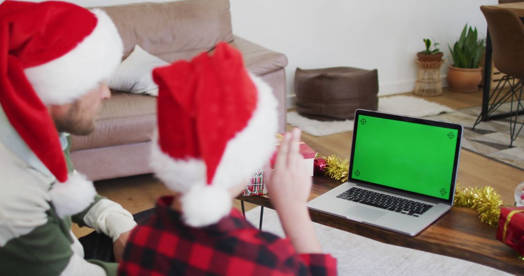 Two People Wearing Santa Hats Videocalling on Laptop with Green Screen During Christmas Celebration - Free Images, Stock Photos and Pictures on Pikwizard.com