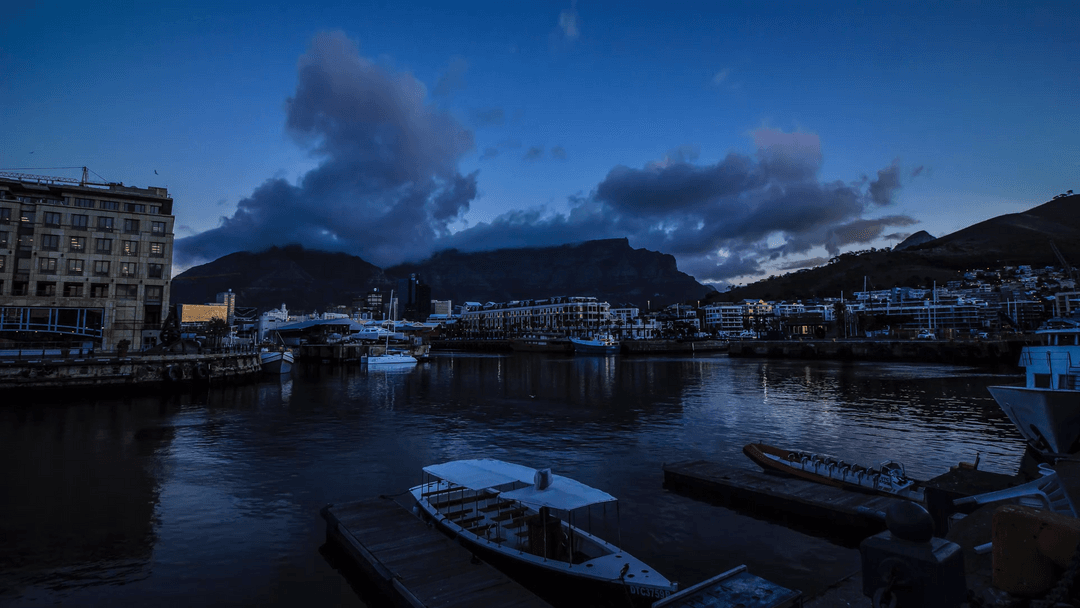 Tranquil Harbor Skyline Reflected on Water at Dusk with Transparent Shadows