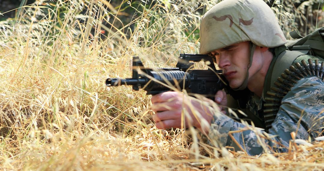 Soldier Camouflaged in Grass with Rifle Aiming - Free Images, Stock Photos and Pictures on Pikwizard.com