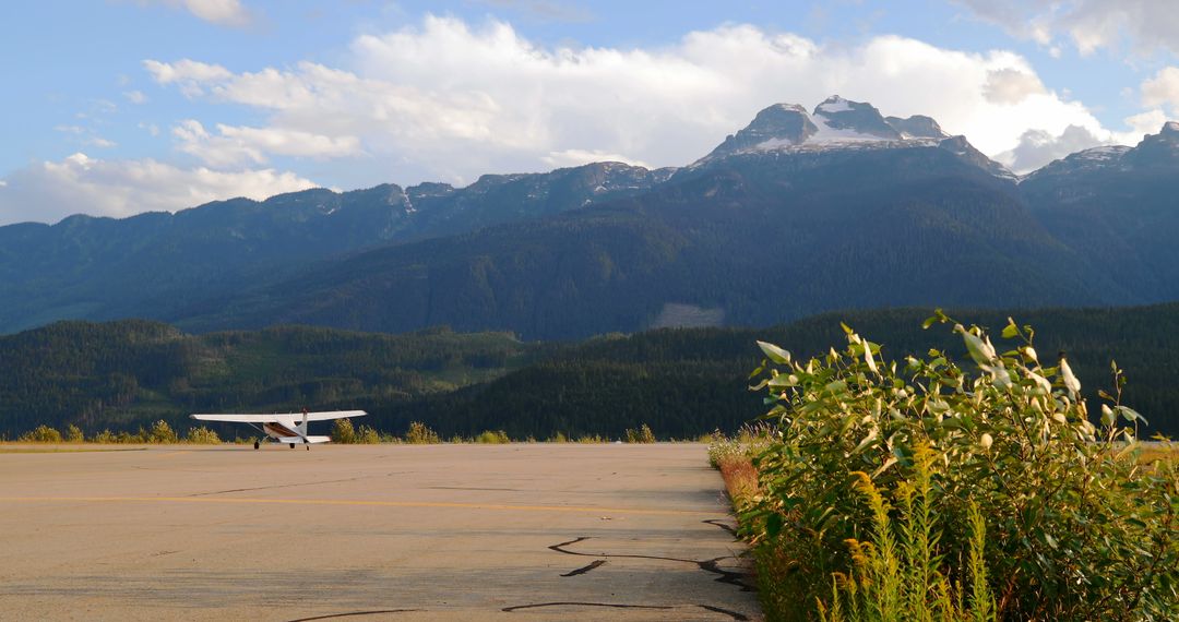 Small Airplane on Mountain Runway with Scenic Background - Free Images, Stock Photos and Pictures on Pikwizard.com