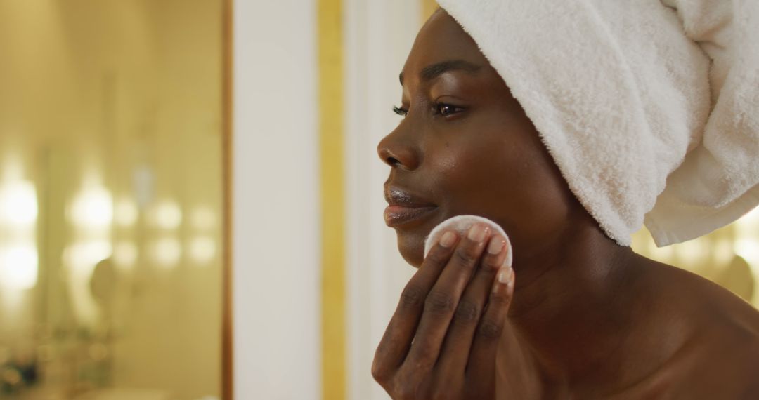 Woman Practicing Skincare Routine With Towel Wrapped Hair - Free Images, Stock Photos and Pictures on Pikwizard.com