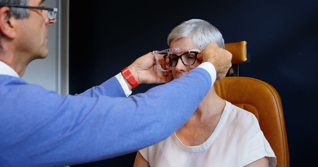 Optometrist Adjusting Glasses for Senior Woman During Eye Exam - Free Images, Stock Photos and Pictures on Pikwizard.com