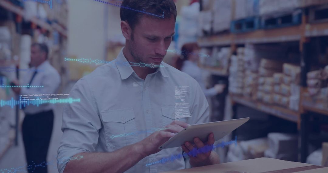 Man Using Tablet in Warehouse for Inventory Management