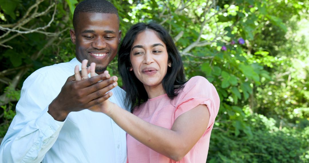 Joyful Couple Embracing During Marriage Proposal in Garden