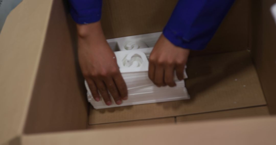 Worker packing fragile items in cardboard box - Free Images, Stock Photos and Pictures on Pikwizard.com