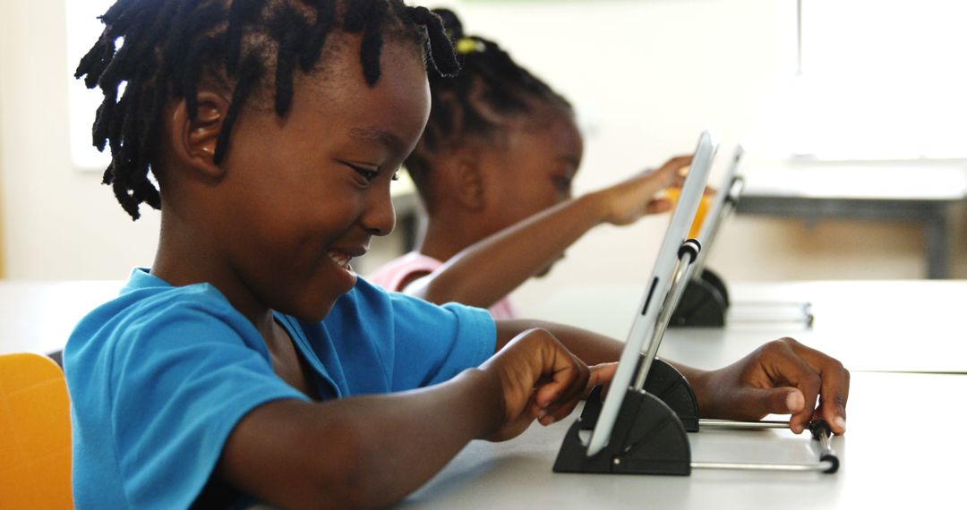 Happy Students Using Digital Tablets in Classroom - Free Images, Stock Photos and Pictures on Pikwizard.com