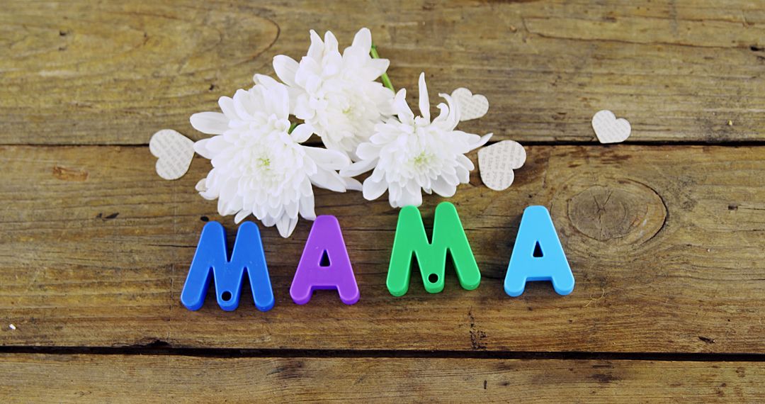 Colorful Letters Spelling Mama with White Flowers on Wooden Surface - Free Images, Stock Photos and Pictures on Pikwizard.com