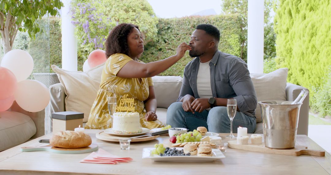 Couple Celebrating Special Occasion with Cake and Champagne Outdoors