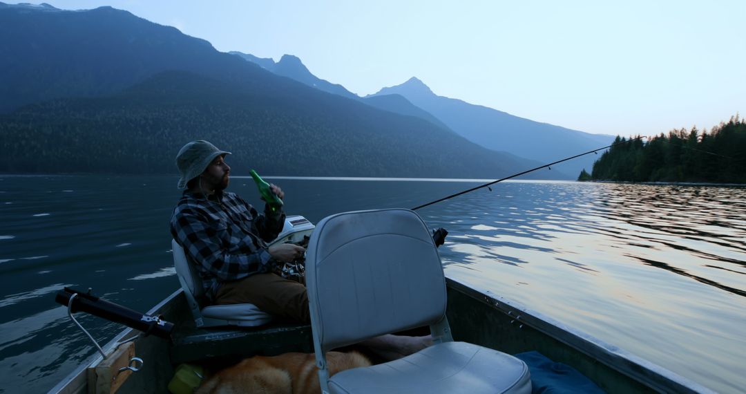 A middle-aged Caucasian man enjoys fishing from a boat on a serene lake at dusk, with copy space - Free Images, Stock Photos and Pictures on Pikwizard.com