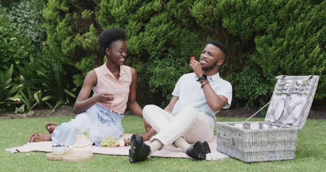 Lovely Couple Enjoying Picnic with Laughter on Grass