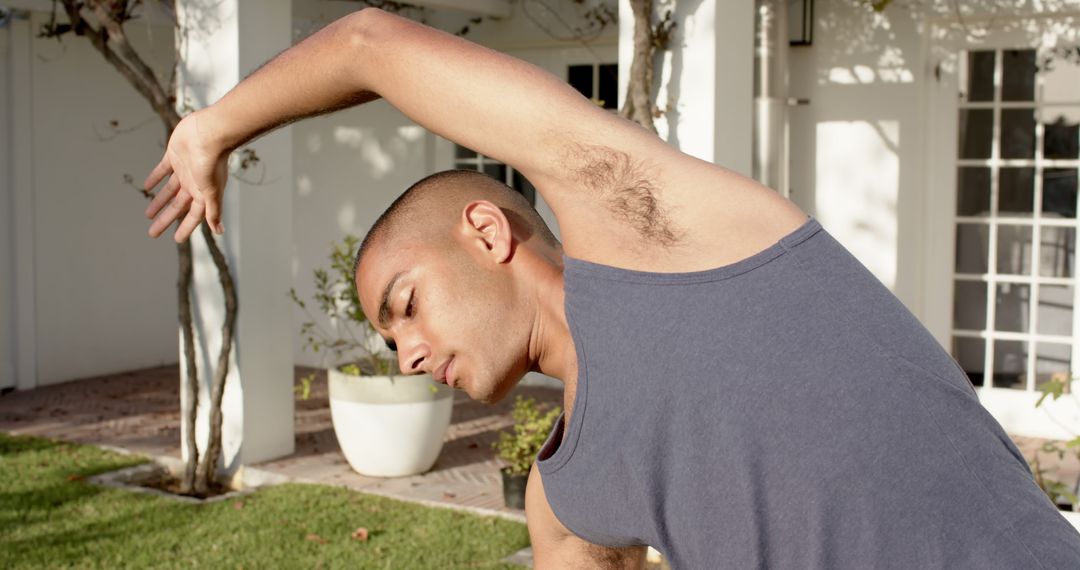 Focused Man Practicing Yoga in Tranquil Sunny Garden