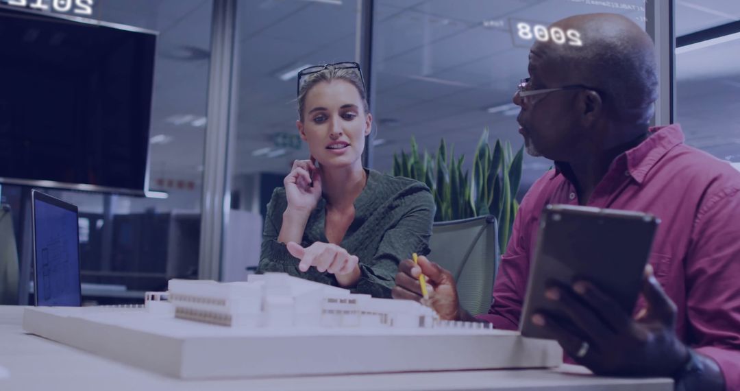 Diverse Colleagues Analyzing Project in Modern Office